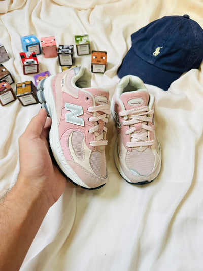 New Balance 2002R kids sneakers pink cream pair