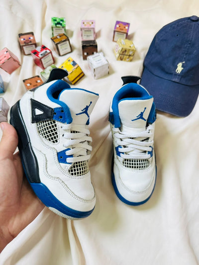 Air Jordan 4 kids sneakers white black blue pair