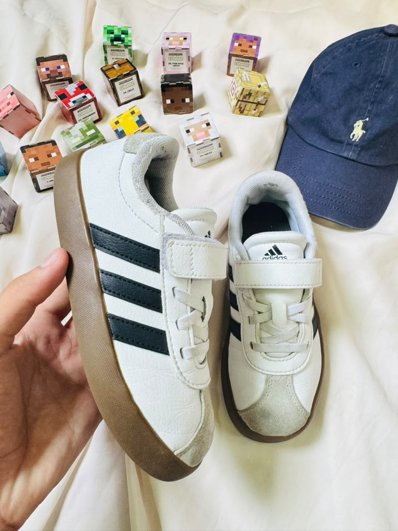 Adidas kids white black gum sneakers front view
