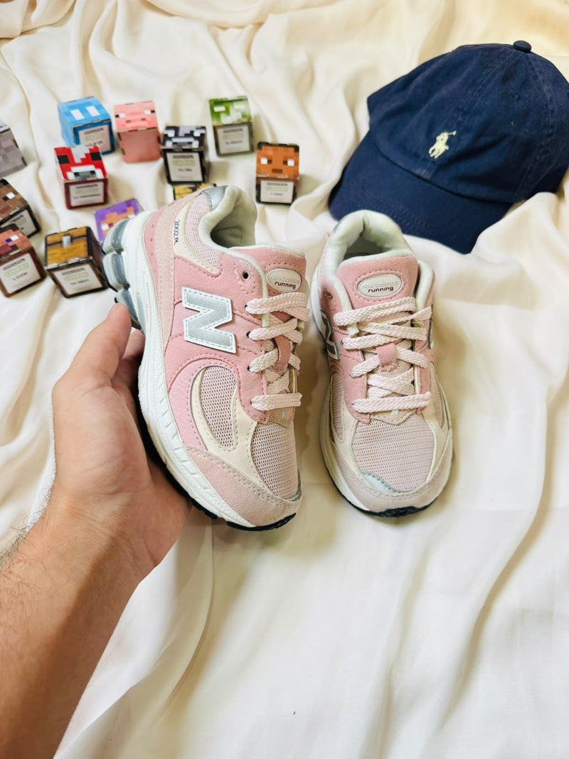 New Balance 2002R kids sneakers pink cream pair