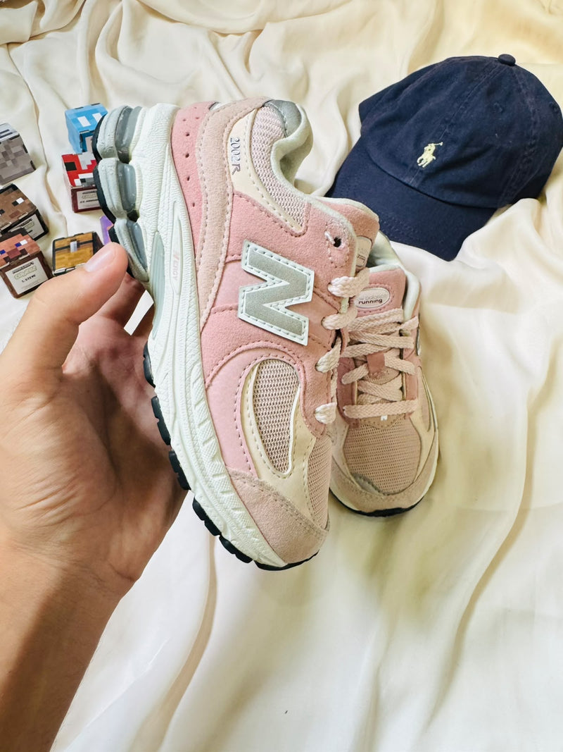New Balance 2002R kids sneaker pink cream side view